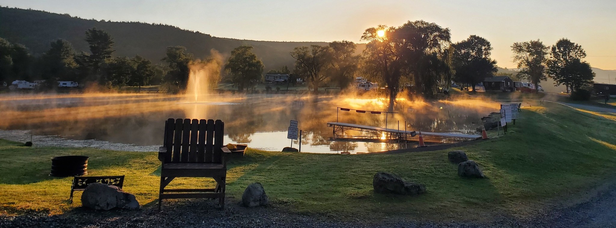 View of pond area and surrounding campsites at sunrise
